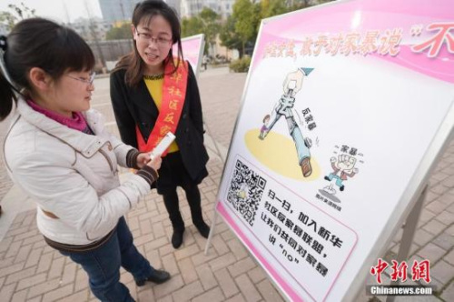 資料圖：今年3月8日，安徽合肥新華社區(qū)志愿者夏一瓊(右)向市民普及反家暴相關(guān)法律知識(shí)。鐘欣 攝